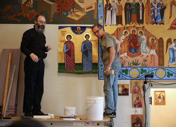 Fr Benjamin & Adrian applying new icon